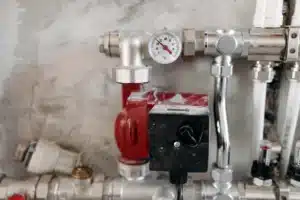 boiler leaking water hamilton Hydronic heating circulator pump, temperature gauge and manifold piping