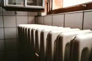hot water radiator heating older home Cast-iron hot water radiator under a window in an older home